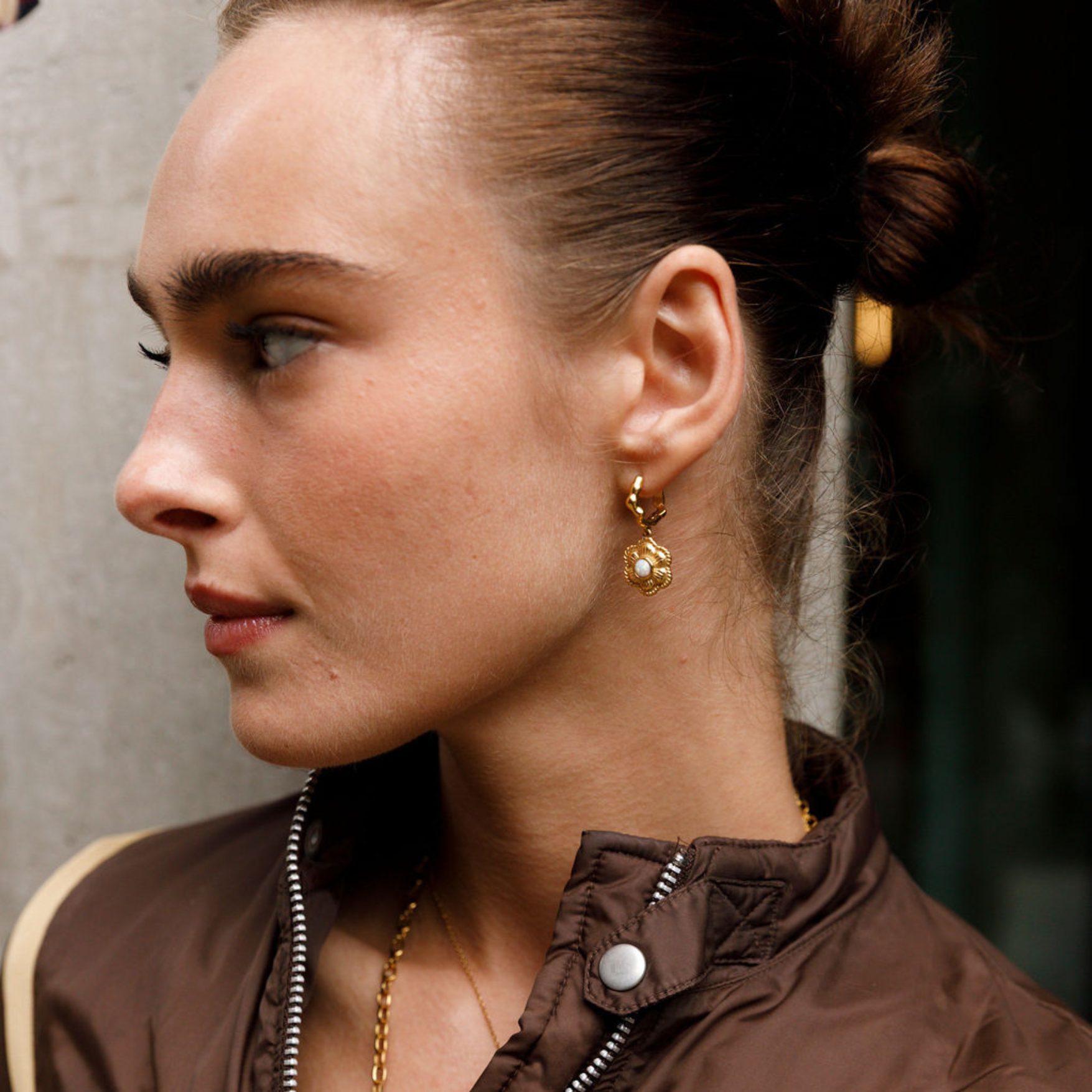 model wearing gold flower earring