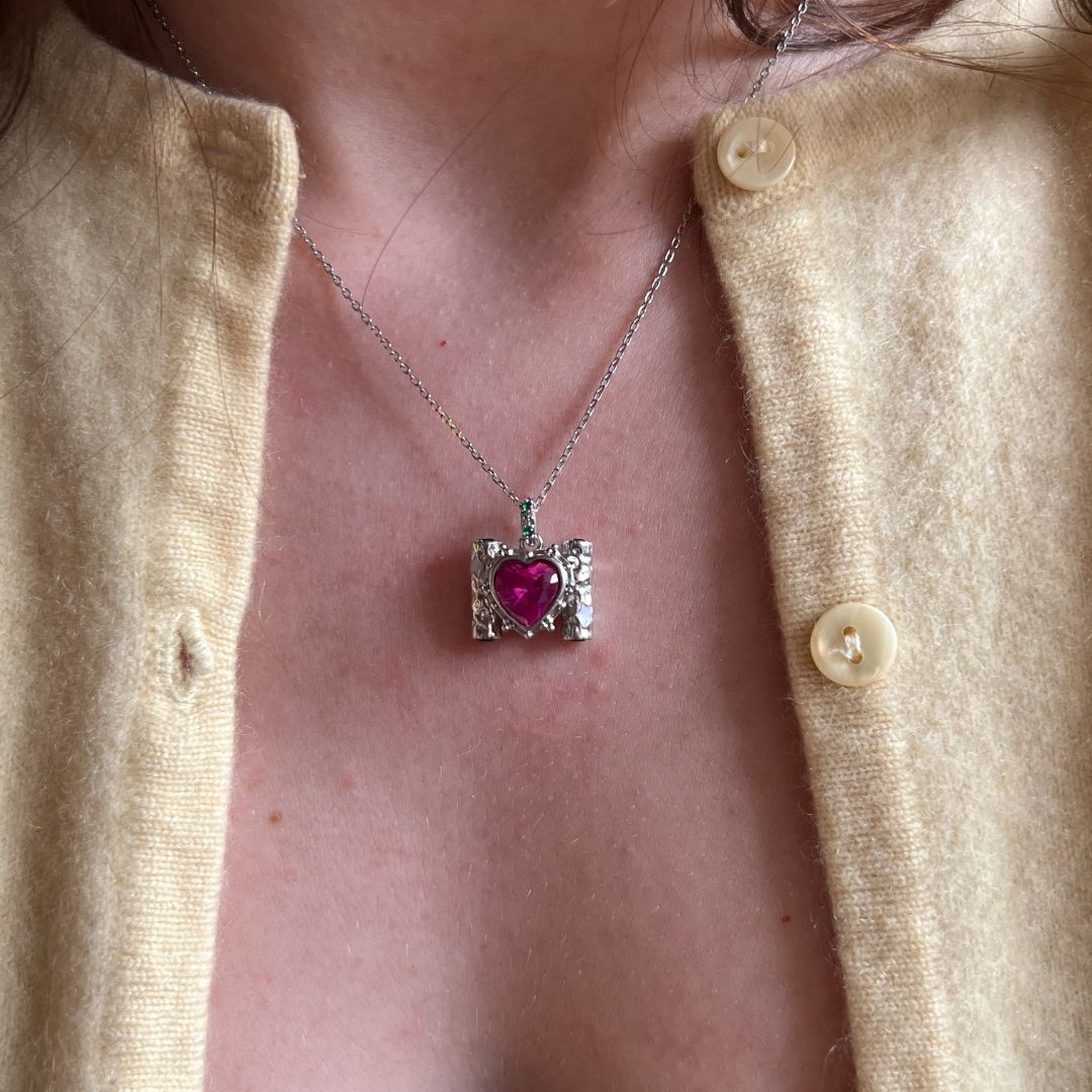 Silver necklace with a heart-shaped pendant.