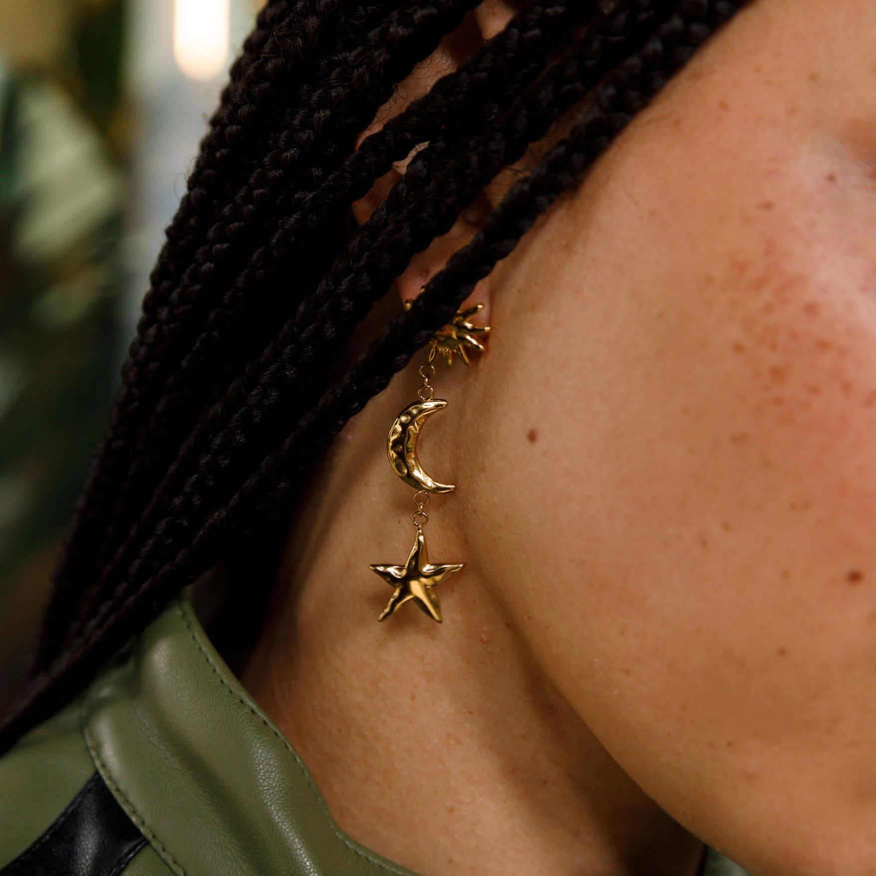 model wearing long sun moon star dangle earrings.