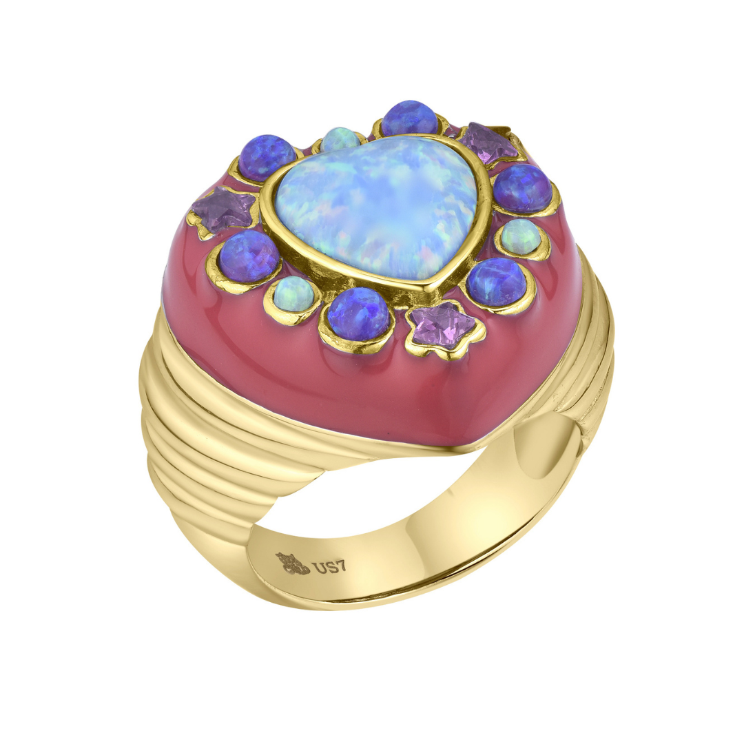 Gold ring with a heart-shaped opal stone and colorful gemstones on a white background