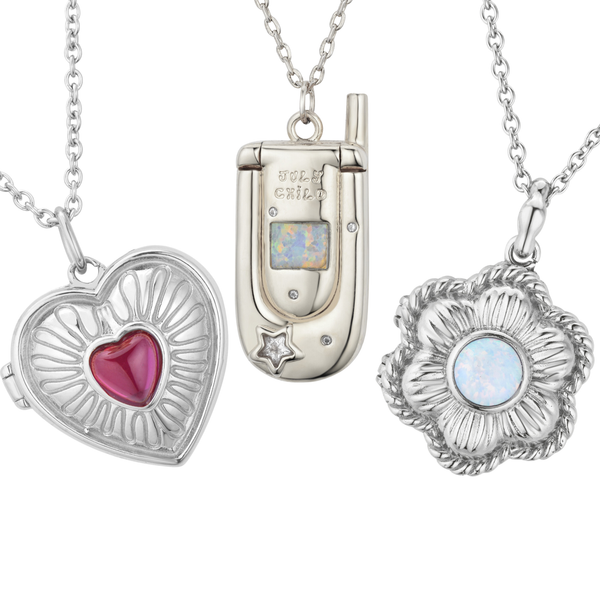 Three silver necklace pendants shaped like heart, phone, and flower.