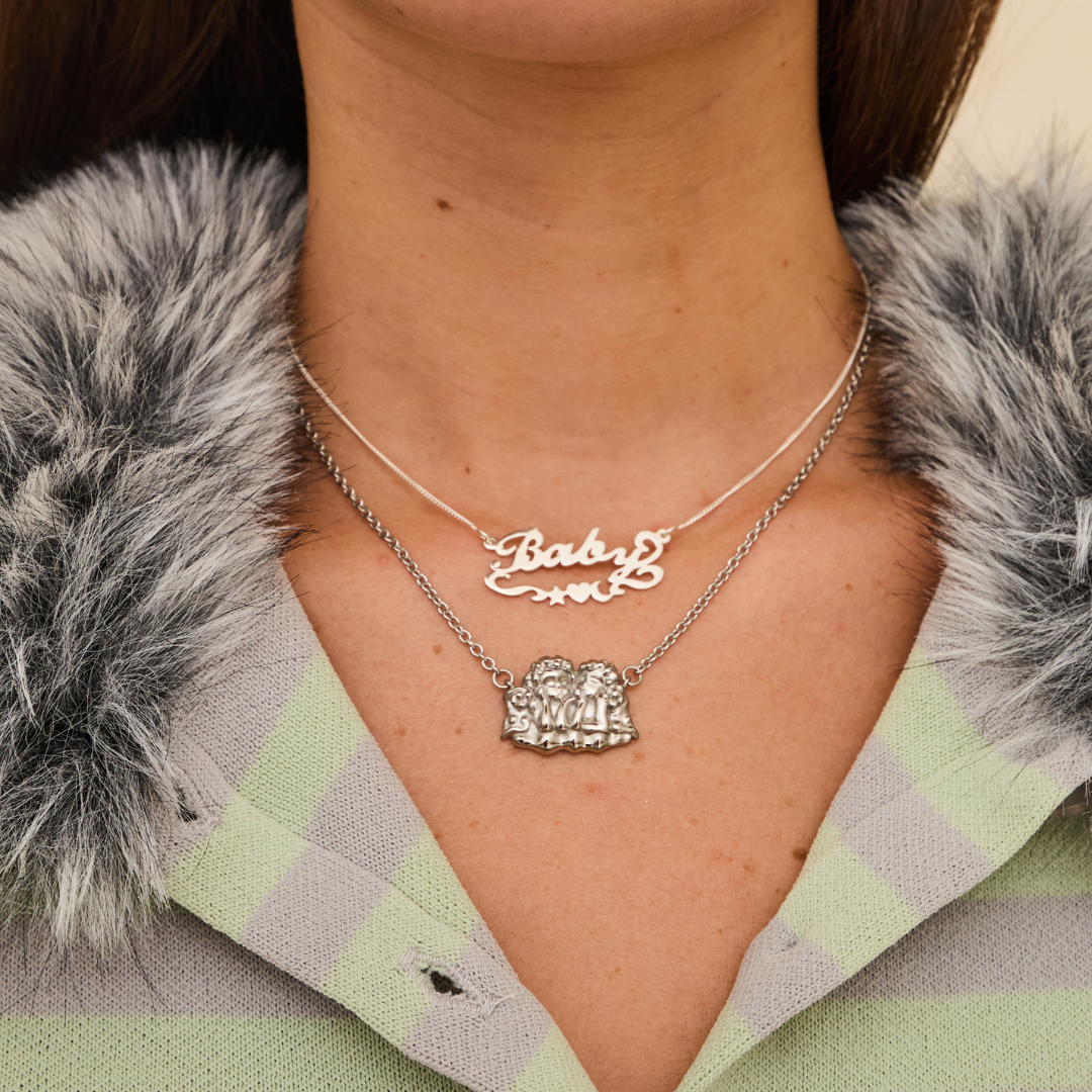 Necklace with 'Baby' and heart pendant.