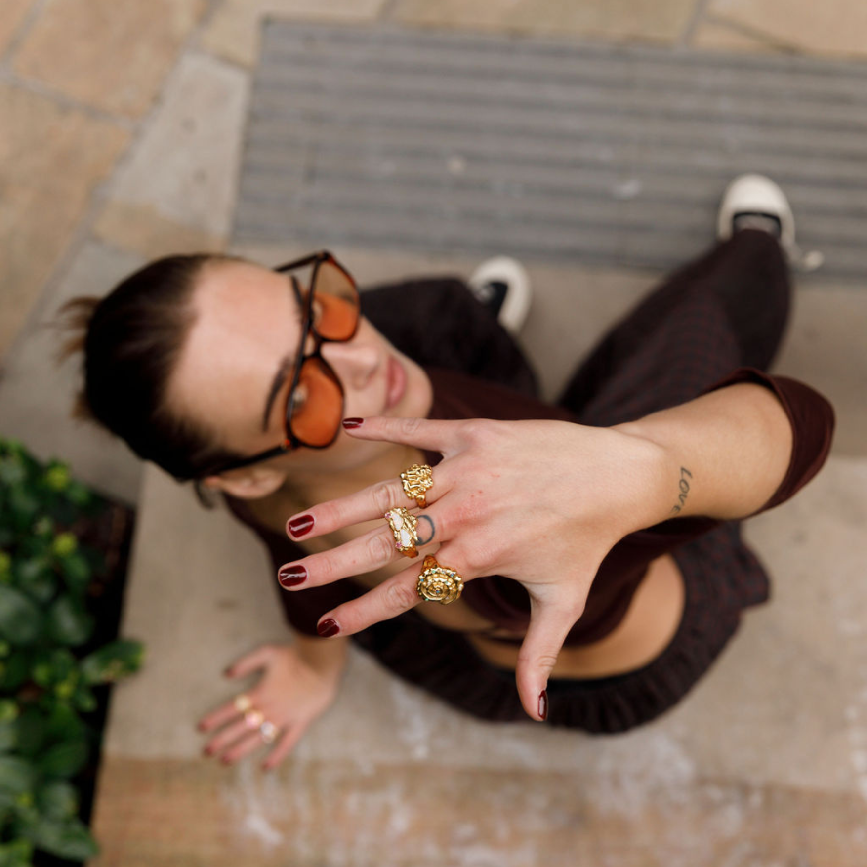 model wearing gold chunky ring stack.