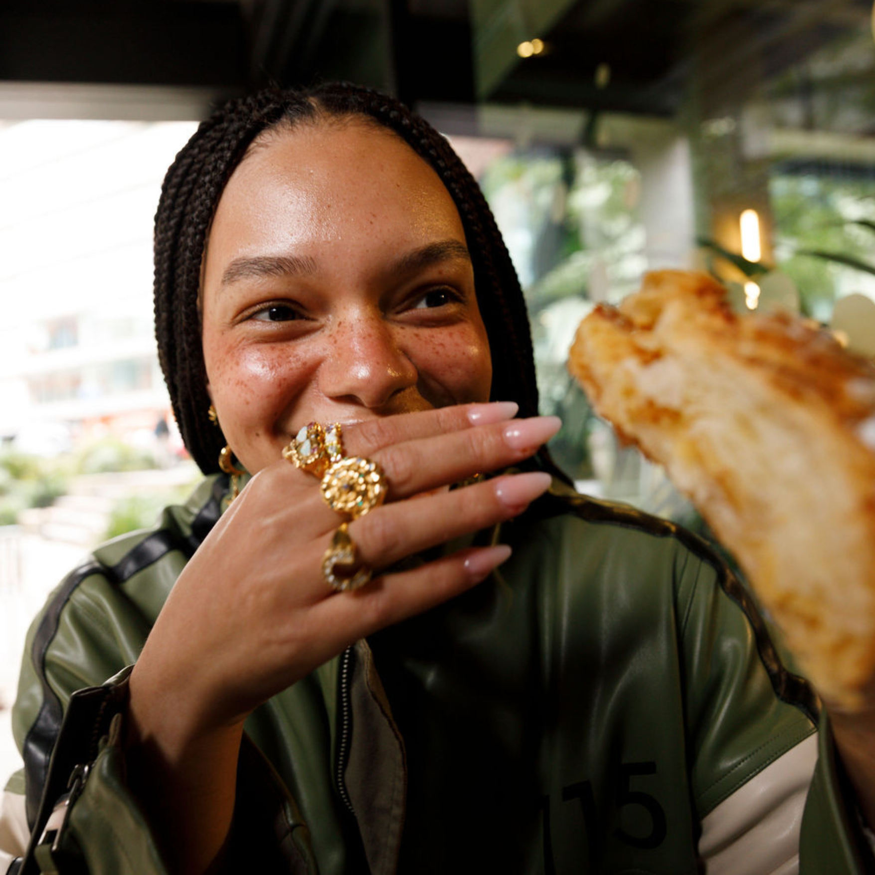 model wearing a gold spiral shell ring.