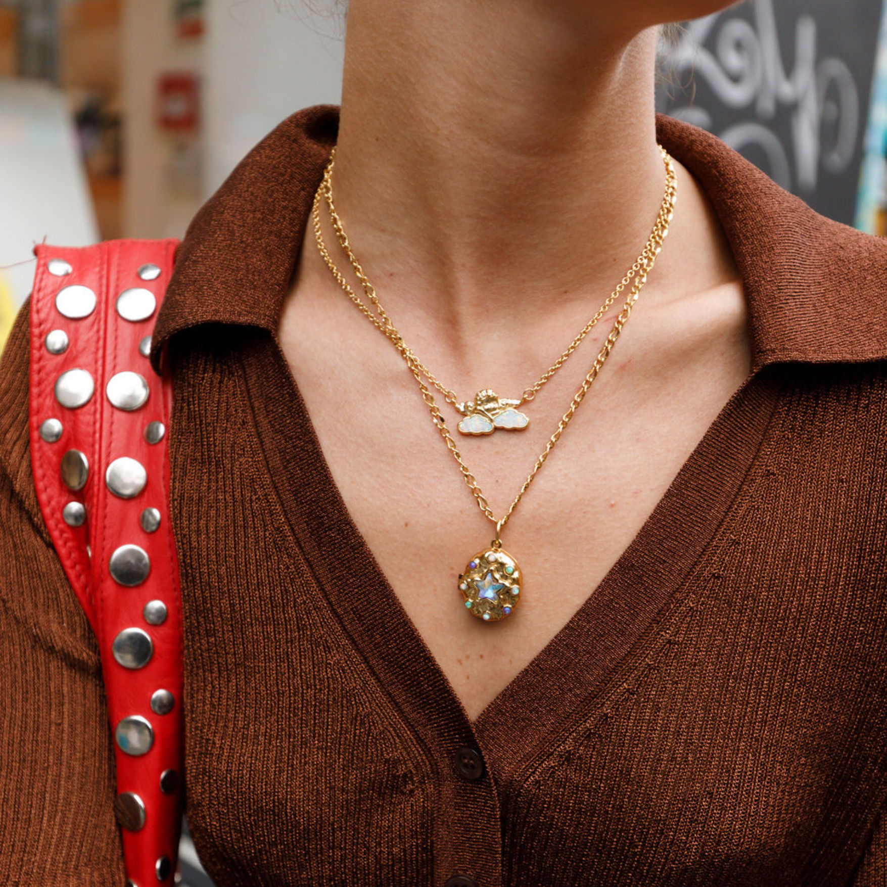 model wearing a gold starlight locket necklace.